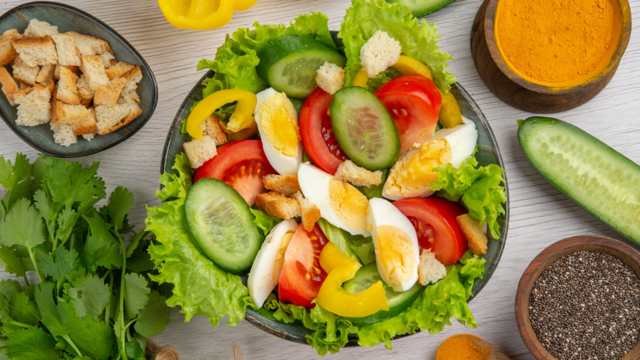 top-view-vegetable-salad-with-eggs-greens-seasonings-white-background-meal-food-ripe-color