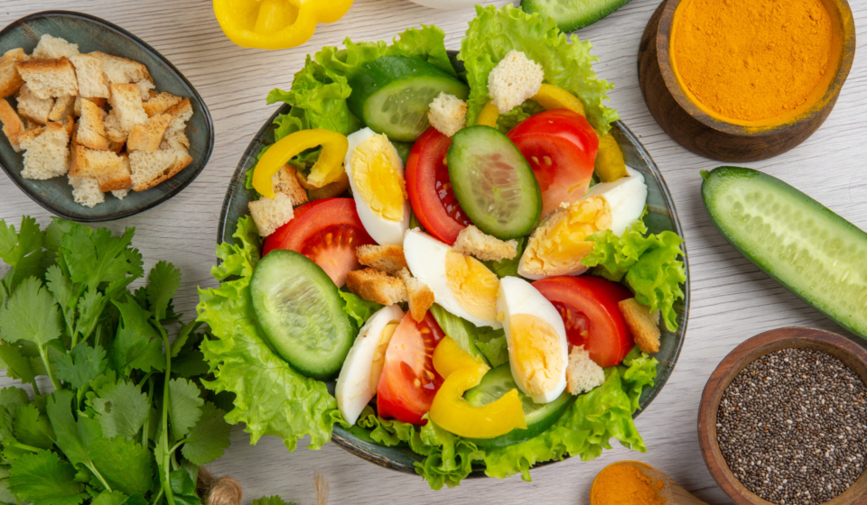 top-view-vegetable-salad-with-eggs-greens-seasonings-white-background-meal-food-ripe-color